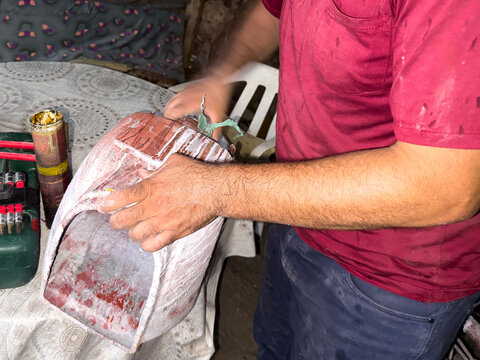 A man is repairing a paint machine.