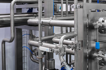 Food production machine with stainless steel pipes, cooling radiator as separator and tanks, valves and measuring instruments.