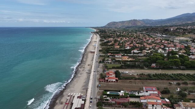 Aerial drone view of Campofelice di Roccella, a charming Sicilian seaside village in northern Sicily, Italy, showing traditional holiday homes, coastline, and panoramic Tyrrhenian Sea vistas