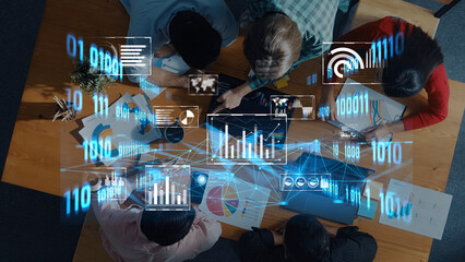 A creative team engages in collaboration while analyzing data on digital interfaces. The environment reflects modern business practices focused on innovation and growth. Trope