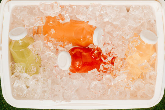 Colorful Drinks in Cooler Filled With Ice