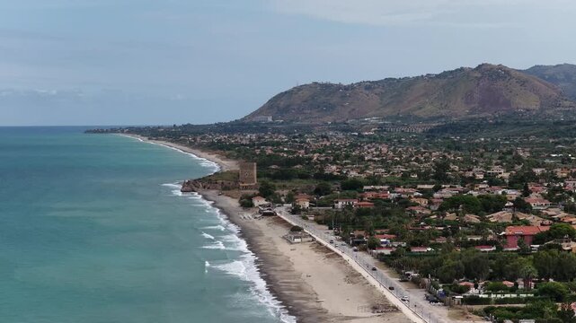Aerial drone view of Campofelice di Roccella, a charming Sicilian seaside village in northern Sicily, Italy, showing traditional holiday homes, coastline, and panoramic Tyrrhenian Sea vistas