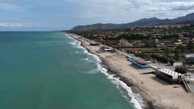Aerial drone view of Campofelice di Roccella, a charming Sicilian seaside village in northern Sicily, Italy, showing traditional holiday homes, coastline, and panoramic Tyrrhenian Sea vistas