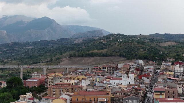 Aerial drone view of Campofelice di Roccella, a historic Sicilian village in Palermo,Sicily, Italy, featuring traditional stone houses, the Madonie Mountains, and the iconic highway viaduct