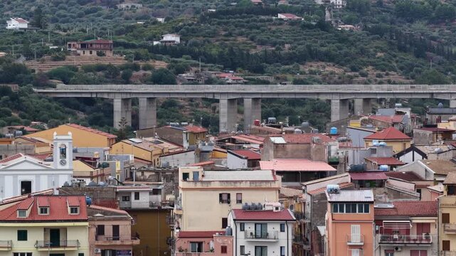 Aerial drone view of Campofelice di Roccella, a historic Sicilian village in Palermo,Sicily, Italy, featuring traditional stone houses, the Madonie Mountains, and the iconic highway viaduct