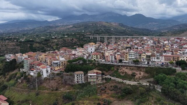 Aerial drone view of Campofelice di Roccella, a historic Sicilian village in Palermo,Sicily, Italy, featuring traditional stone houses, the Madonie Mountains, and the iconic highway viaduct