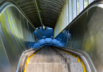 Empty escalator descending in modern station