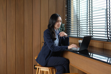 A young female employee is busy with an online seminar.