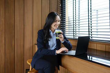 A young female employee is busy with an online seminar.