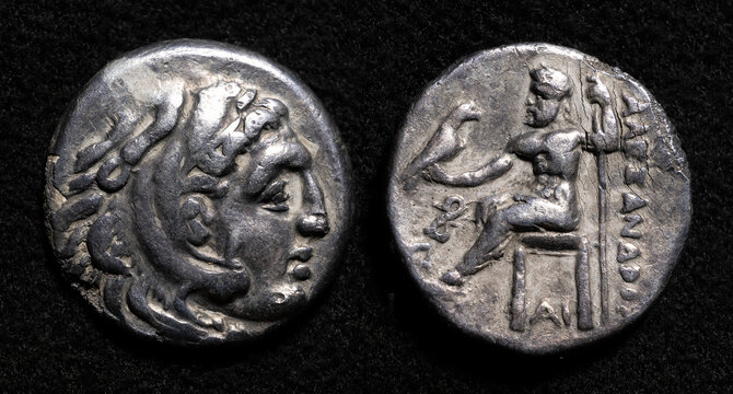 Ancient Greek coin of Alexander the Great, old silver drachma, textured vintage money isolated on dark background
