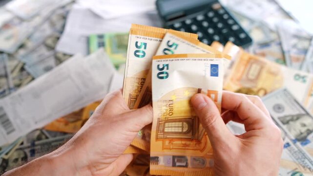 Man calculating money, monthly home expenses, taxes and bank account balance.