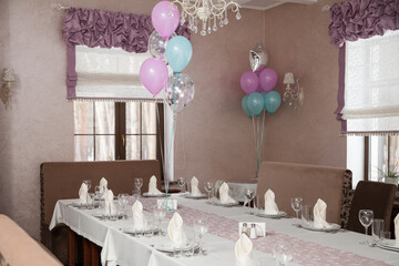Beautiful banquet hall interior decorated with pastel balloons and neatly set tables with white napkins and glassware. Perfect for events, weddings, or restaurant advertising.