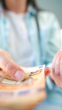 Woman counting euro bills, close-up. Vertical video