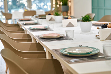 A Beautifully Set Dining Table with Elegant Tableware, Featuring Plates, Glasses, and Natural Decor for an Inviting Eating Experience