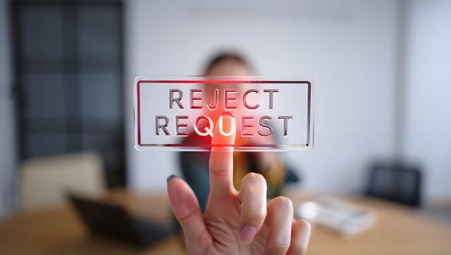 Person s finger pressing a glowing red reject request button on a screen