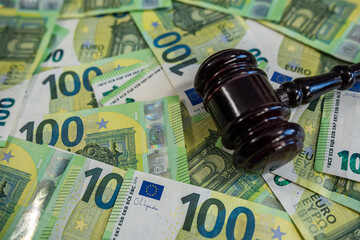 Close-up of multiple 100 euro banknotes spread out, symbolizing finance, savings, and investment