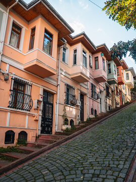 View of the colorful and well-preserved historic houses line a steep cobblestone street, creating a charming and picturesque atmosphere, Balat, &Auml;&deg;stanbul, T&Atilde;&frac14;rkiye.