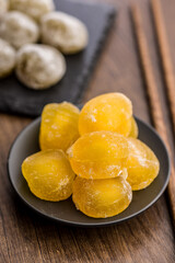 Japanese mochi dessert on plate on wooden table.