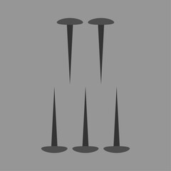 Set of five thumbtacks or pushpins displayed on a plain gray background for conceptual use