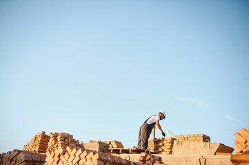 Construction worker in uniform and safety equipment have job on building