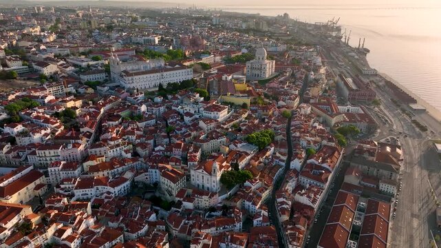 Aerial view of the cityscape with buildings and roads, showing the contrasting red rooftops nestled against the white walls, Lisbon, Lisbon, Portugal.