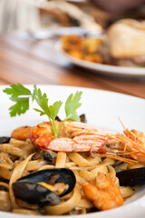 pasta dish al mare seafood with shrimp and shellfish in restaurant close-up