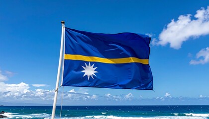 National flag waving proudly against a vibrant blue sky and ocean