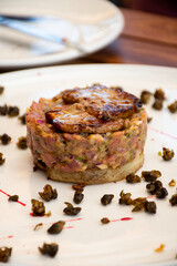 beef tartare with mushrooms and capers in bistro restaurant close-up