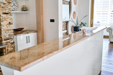 Stylish Modern Kitchen Island with Polished Countertop, Elegant Décor, and Cozy Living Area Featuring Natural Elements and Contemporary Design