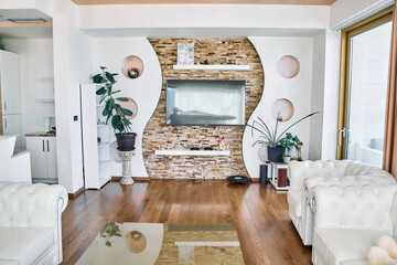 Modern Living Room with Stylish Decor Featuring a Stone Wall, Elegant Furniture, and Lush Greenery for a Cozy Atmosphere