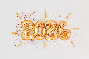 New 2026 Year. Golden numbers balloons and glowing confetti on a blue background.