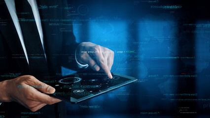 A businessman engages with a digital tablet, navigating a modern interface filled with data and analytics, symbolizing technological advancement in business scenarios. Xenic