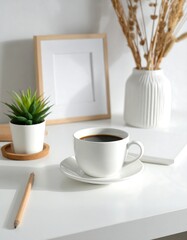 A clean, minimalist workspace with a cup of coffee, a succulent, and a framed photo