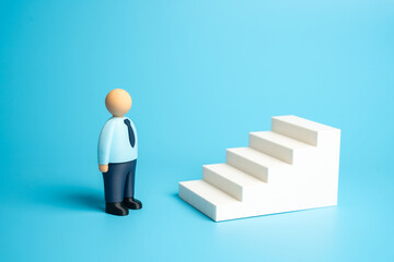 An office worker looks up a ladder. Concept: mastering skills. Starting a new career from the bottom. Fulfilling all requirements for promotion. Ambition, career development. HR, motivation, education