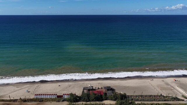 Aerial drone view of Campofelice di Roccella, a charming Sicilian seaside village in northern Sicily, Italy, showing traditional holiday homes, coastline, and panoramic Tyrrhenian Sea vistas