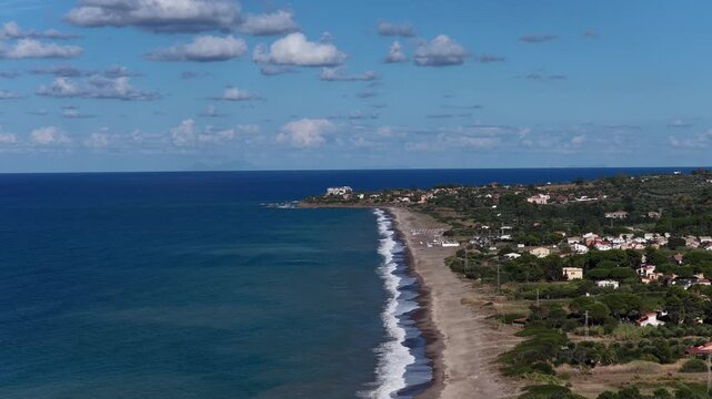 Aerial drone view of Campofelice di Roccella, a charming Sicilian seaside village in northern Sicily, Italy, showing traditional holiday homes, coastline, and panoramic Tyrrhenian Sea vistas