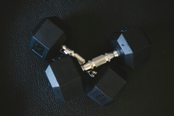 Weights arranged on a gym floor, showcasing fitness tools for strength training and muscle building...