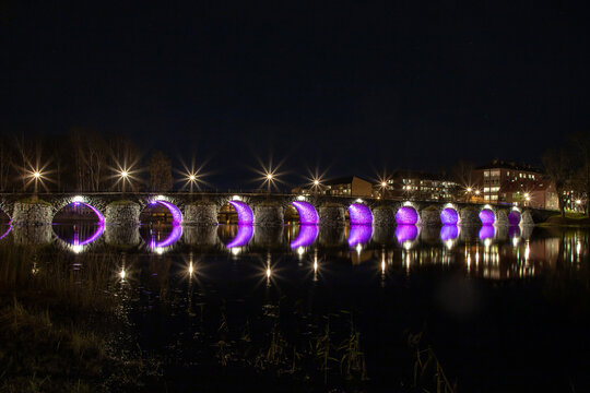 Illuminated old stone bridge by night , Karlstad , Sweden