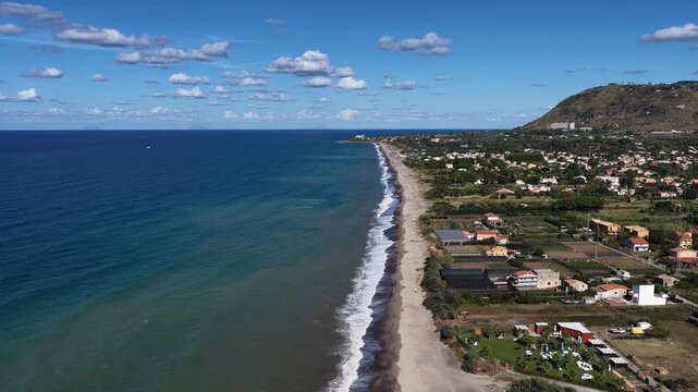 Aerial drone view of Campofelice di Roccella, a charming Sicilian seaside village in northern Sicily, Italy, showing traditional holiday homes, coastline, and panoramic Tyrrhenian Sea vistas