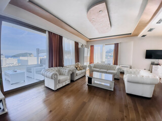 A Bright and Modern Living Room Featuring Plush White Sofas, Natural Light, and Elegant Décor for a Cozy Yet Chic Ambiance