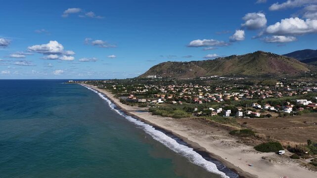Aerial drone view of Campofelice di Roccella, a charming Sicilian seaside village in northern Sicily, Italy, showing traditional holiday homes, coastline, and panoramic Tyrrhenian Sea vistas
