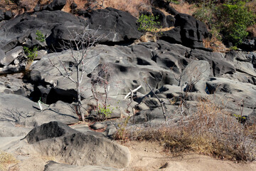 The unusual dark rock formation at the Vale da Lua in Chapada dos Veadeiros near the city of Alto Paraiso, Brazil
