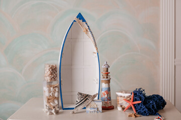 Nautical decor with lighthouse, seashells and mirror