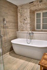 Elegant Bathroom Design Featuring a Freestanding Bathtub, Modern Shower Area, and Natural Stone Elements Creating a Sanctuary of Relaxation and Comfort