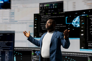 Black professional software engineer programming for tech innovation, reviewing data and binary code on the dashboard. IT specialist examining programming language code for transformation.