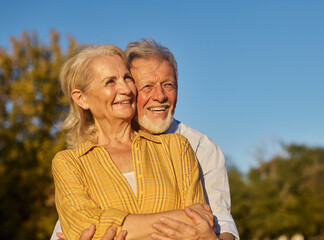 Happy active senior couple having fun in park outdoors