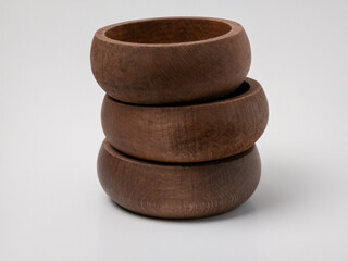 Stack of three handmade wooden bowls on white background