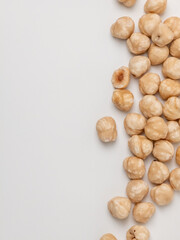 Raw hazelnuts on white background with copy space