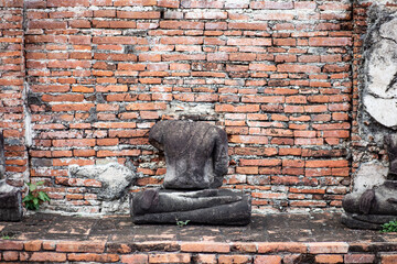 Headless buddha sculpture on a ruined temple in Ayutthaya, Thailand