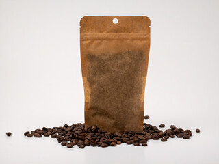 Brown kraft paper coffee bag with coffee beans on white background